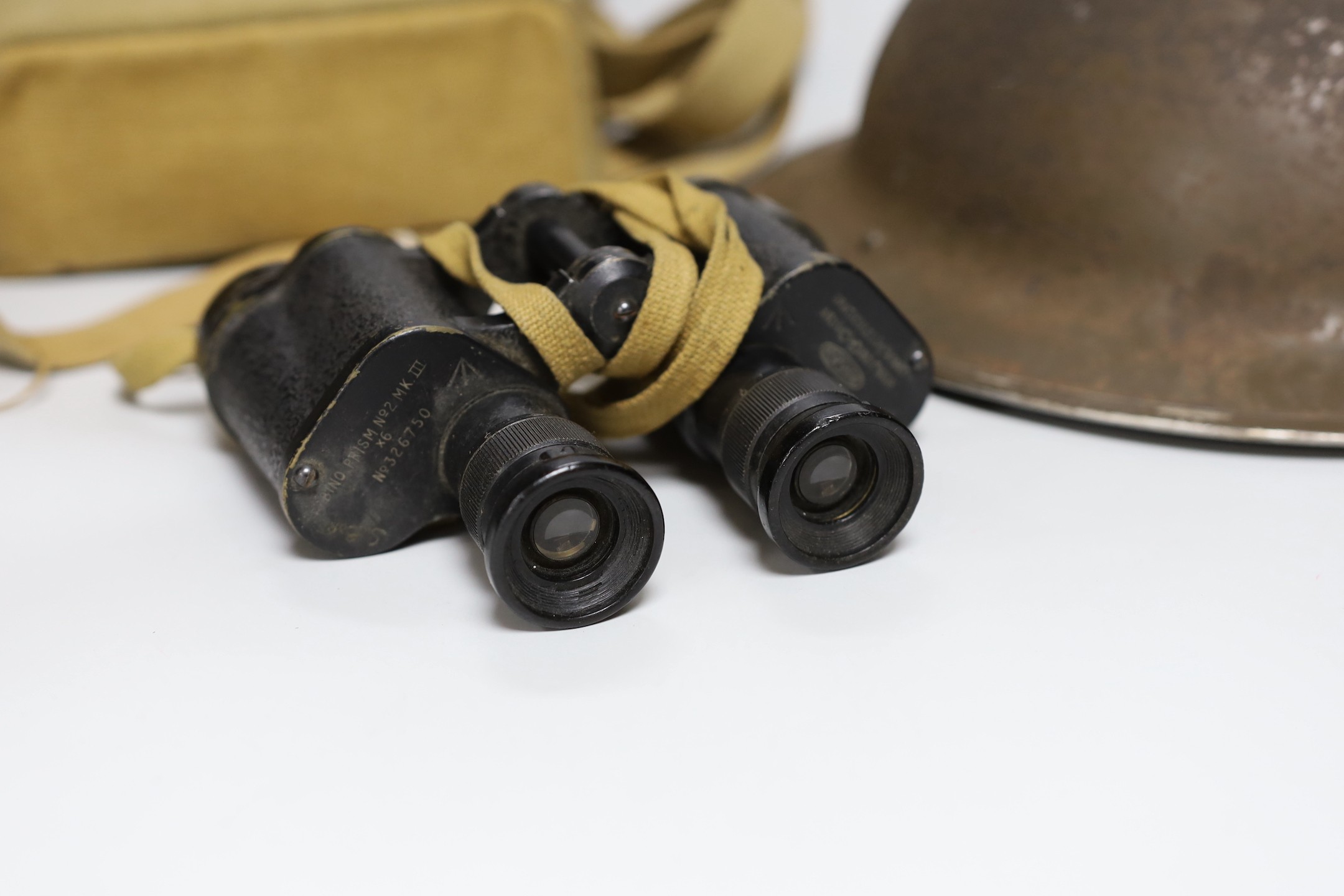 A British WWII military helmet and a pair of Kershaw military binoculars No. 326750